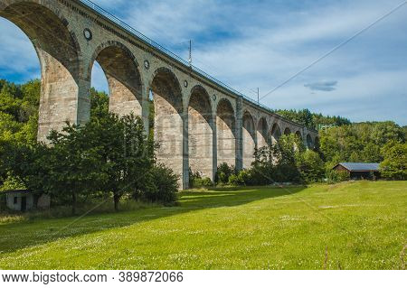 Train Viaduct In Altenbeken,  North Rhine Westphalia, Germany. Old Stone Railway Surrounded By Green