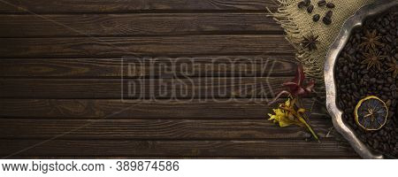 Vintage Silver Tray With Coffee Beans, Spices And Flowers On A Table From Wooden Old Textured Boards