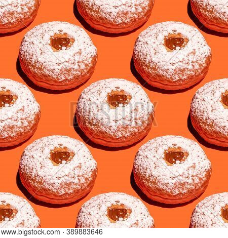 Seamless Pattern With Traditional Doughnut Sufganiya For Jewish Holiday Hanukkah On Orange Backgroun