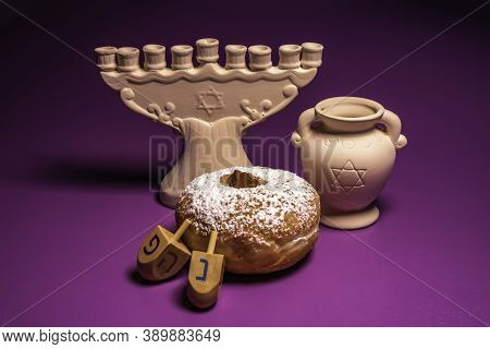 Menorah, Oil Jar, Traditional Doughnut Sufganiya, Dreidels For Jewish Holiday Hanukkah On Violet Bac