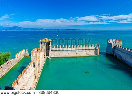 Sirmione, Italy, September 11, 2019: Small Fortified Harbor With Turquoise Water, Scaligero Castle C