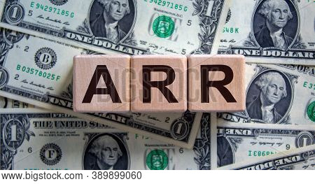 Wood Cubes With Acronym Arr - Annualized Run Rate On A Beautiful Background From Dollar Bills. Busin