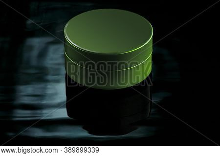 Small Green Jar In Water With Reflection On A Dark Background. Mockup For Advertising Cream, Lation,