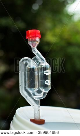 Homemade Moonshine Winemaking; Airlock In White Barrel For Home Brandy Production