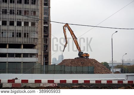 Moscow / Russia - October 13 2020: An Excavator Equipped With Special Equipment Is Preparing To Demo