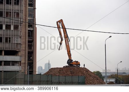 Moscow / Russia - October 13 2020: An Excavator Equipped With Special Equipment Is Preparing To Demo