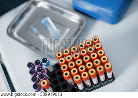 Top View Of Vials With Medical Experimental Liquid That Stands On White Surface.