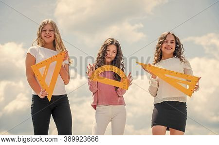 Education Concept. School Students Learning Geometry. Girls With Triangle Ruler. Smart Friends. Scho