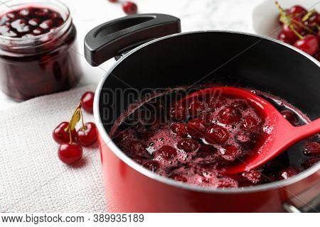Pot With Cherries In Sugar Syrup On Table, Closeup. Making Delicious Jam
