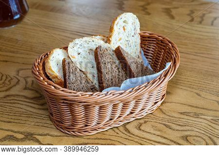 Black And White Bread In A Basket. Sliced ??bread In A Basket. Pieces Of Bread Are Ready To Eat