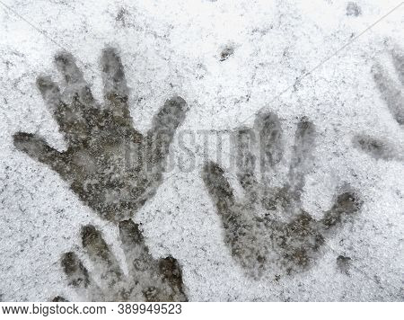 Child Hand Prints In The Snow. The Impact Of Human Heat On Snow. A Handprints On A Slightly Melted S