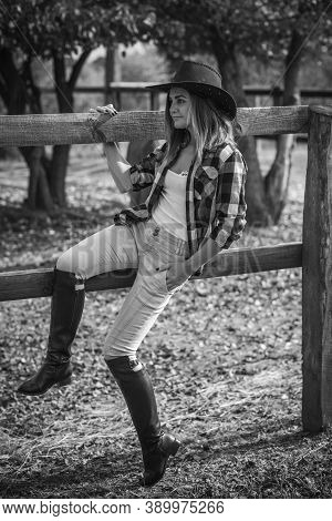 American Woman On A Horse Farm. Portrait Of Girl In Cowboy Hat With A Horses. Hippotherapy At Nature