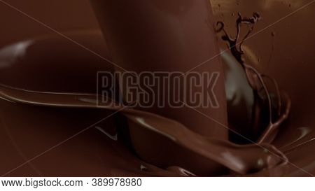 Detail of pouring hot chcocolate with splash. Studio macro shot.