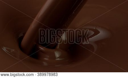 Detail of pouring hot chcocolate with splash. Studio macro shot.