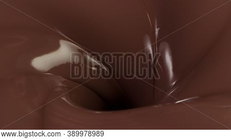 Detail of pouring hot chcocolate with splash. Studio macro shot.