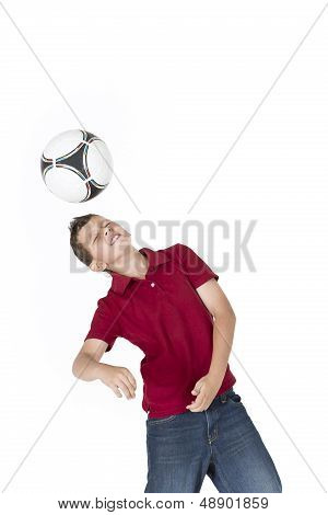 Boy kicking soccer ball with his head