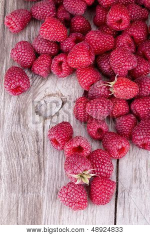 Sweet raspberry on wooden tables