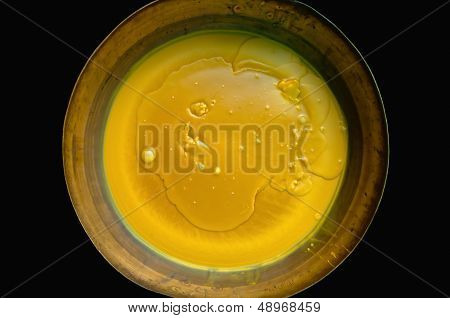 Melt wax in a brass pan.
