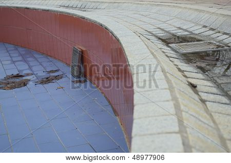 Empty Wet Swimming Pool With Leafs