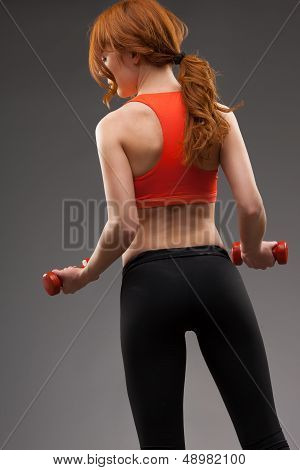 woman exercising with dumbbells