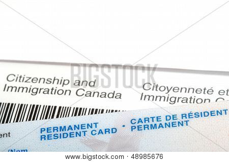 Permanent Resident  Card Over Immigration Canada Letter