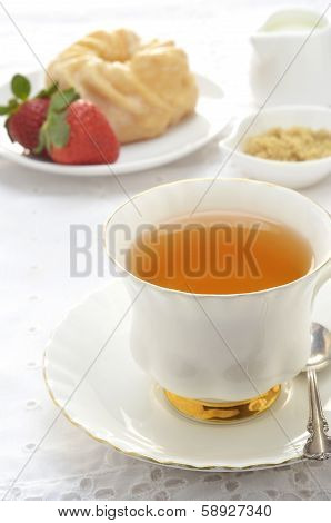 Tea  With Glazed Cruller And Strawberries