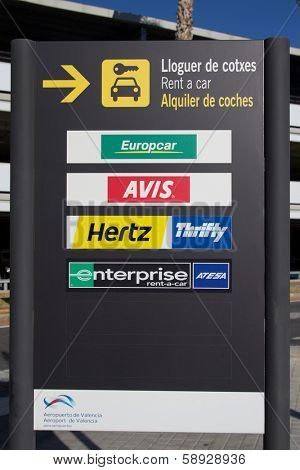 VALENCIA, SPAIN - JANUARY 21, 2014: A rental car sign at the Valencia airport. The rental car industry is a 31 billion dollar industry worldwide with Hertz having 28% of the market share. 