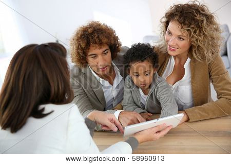 Family meeting real-estate agent for home purchase