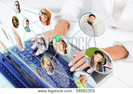 social networking, communication, technology and internet concept - businesswoman using her laptop computer