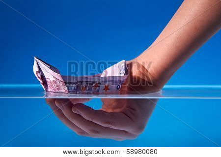 Economy Recovery Concept: Hand helping a EURO bill boat