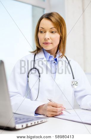 medicine and healthcare concept - busy doctor with laptop computer