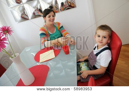 happy young family eating tasty pizza with cheesa and dring healthy and fresh orange juice