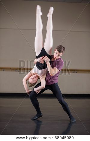 Ballet partners dancing gracefully together in the ballet studio