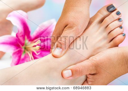 Reflexologist Working On Female Foot
