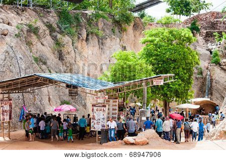 Tourists posing with tigers at the Tiger Temple in Kanchanaburi, Thailand.