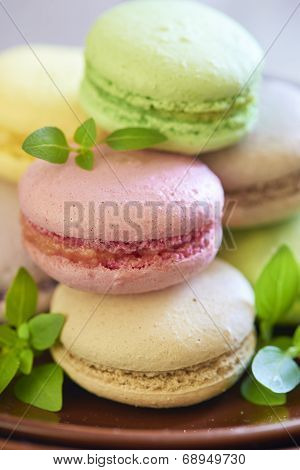 Colorful macaroons on brown plate