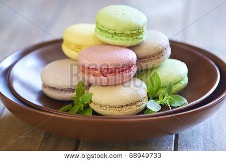 Colorful macaroons on brown plate