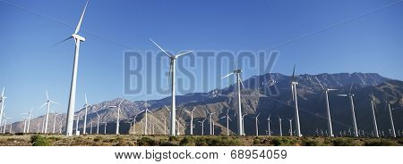 Valley of wind turbines in desert