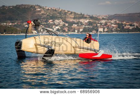 Portoroz, Slovenia - 6 May, 2014: Men riding a motorised vessel on foils in the sea.