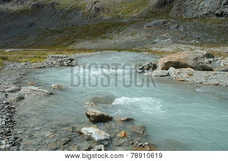 Gill In Valley Nearby Glacier In Alps In Switzerland