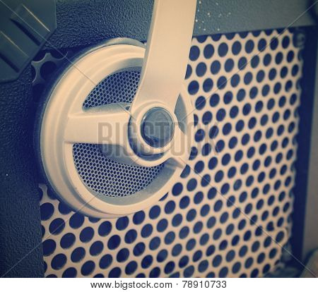 Close Up Of A Guitar Amplifier Grill With A Headset On It