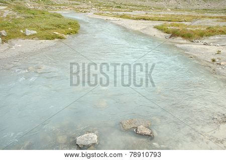 Gill In Valley Nearby Glacier In Alps In Switzerland