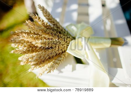 Spikelets Of Wheat In A Bouquet Laying On The Grass
