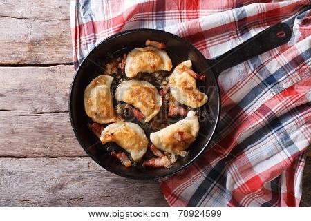 Fried Dumplings With Onion And Bacon In A Pan Horizontal Top View