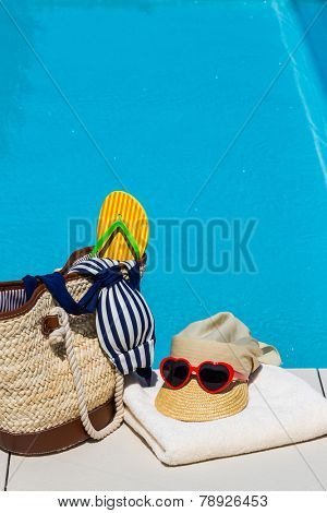 utensils for a nice relaxing vacation day lying next to a swimming pool. relaxation on vacation.