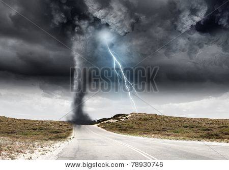 Powerful tornado and lightning above countryside road