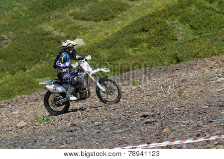 SOCHI, RUSSIA  AUGUST 16, 2014: Off-road motorcycle rider trains in summer mountains