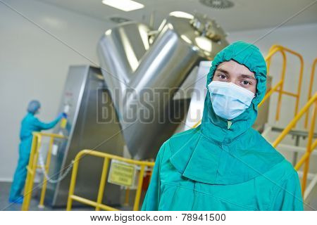 pharmaceutical factory workers in front of powder mixer machine during tablet production at pharmacy industry manufacture factory