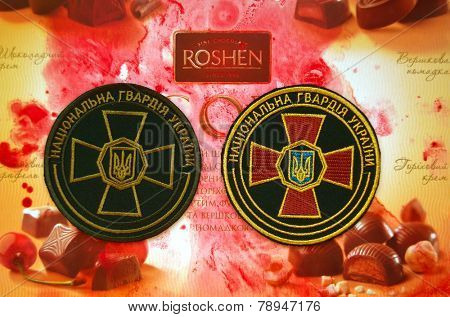 Kiev,Ukraine.Dec 20.Illustrative editorial.Chevron of Ukrainian National Guard.With logo Roshen Inc. Trademark Roshen is property of ukrainian president Poroshenko.At December 20,2014 in Kiev,Ukraine 