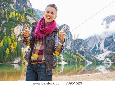 Portrait Of Smiling Young Woman On Lake Braies Showing Thumbs Up